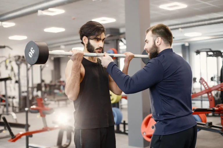 indian-man-doing-excercisses-special-equipment-gym-with-personal-trainer